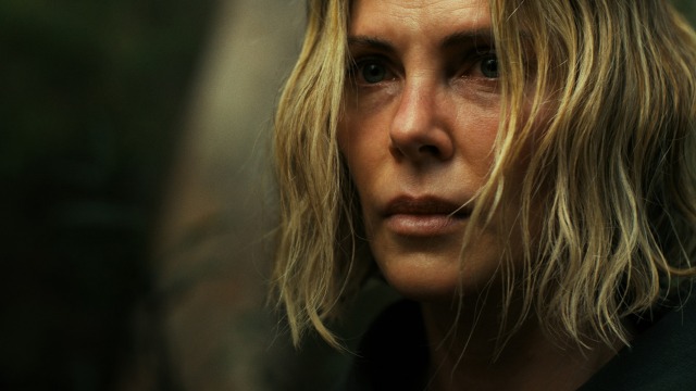 alt="Charlize Theron looking determined and scared in the film Apex"