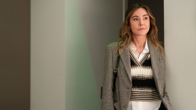 alt="Christa Miller as Liz standing in a hallway in Shrinking.jpg"