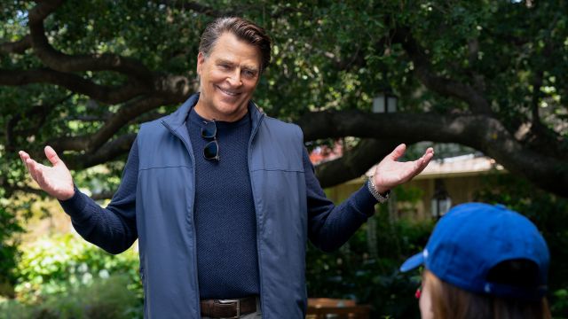 alt="Ted McGinley as Derek with his hands up in a shrug in Shrinking"