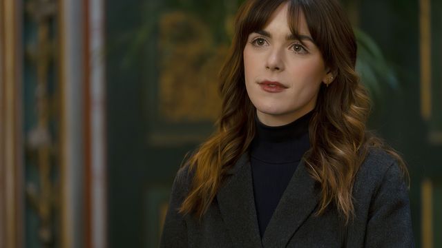 alt="Kiernan Shipka as Haley Clay wearing a dark turtleneck and blazer"