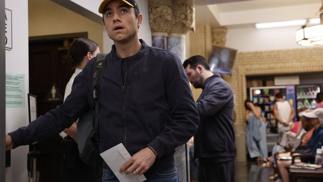 alt="Dr. Frank Langdon stands in a busy hospital hallway looking concerned."